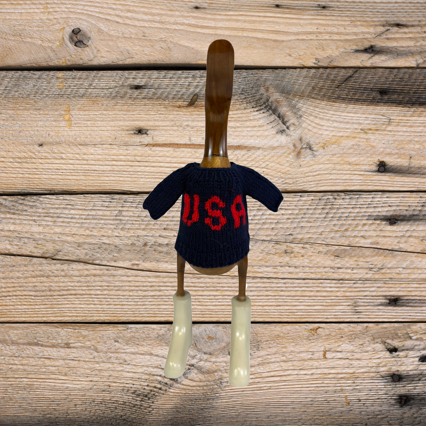 Hand-knit navy sweater with USA duck design by COLLAB BY AMERICAN/HOLIDAY™, featuring detailed duck embroidery and cozy knit texture.
